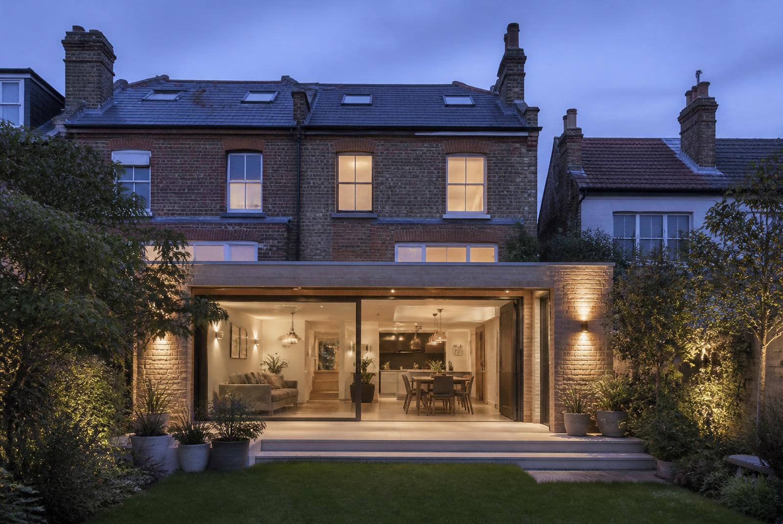 Rear extension on a British brick family home at dusk — illustrative reference